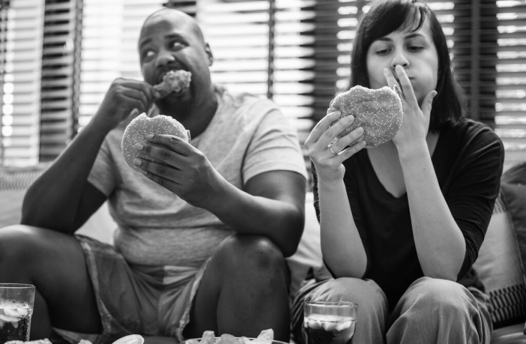 Couple having fast food on the couch