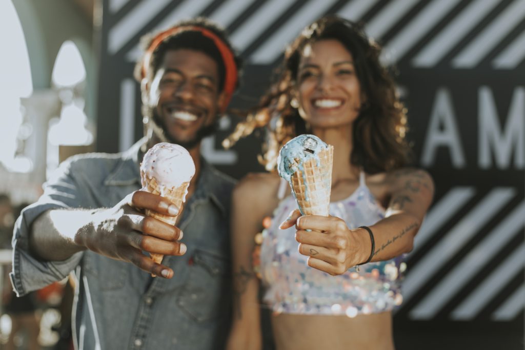 Cheerful couple enjoys ice cream without guilt